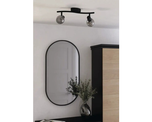 Tweelamps plafondlamp met ovale spiegel in een lichte kamer