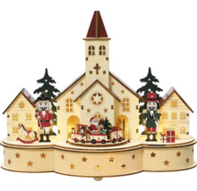 Verlichte kerstdecoratie met kerk, notenkrakers en trein