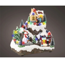 Decoratieve kerstscène met huizen, bomen, sneeuwpop en figuren