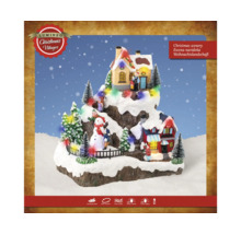 Verlicht kerstlandschap met huizen en figuren