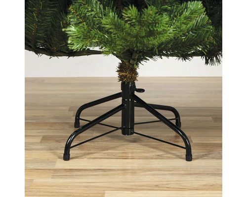 Detailopname van een kunstkerstboom met metalen voet.